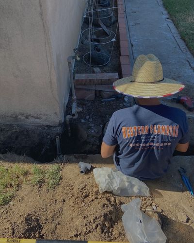 Western Plumbing Employee in a Trench